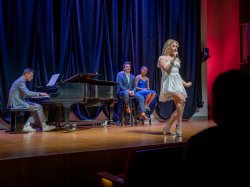 Student sings on stage.