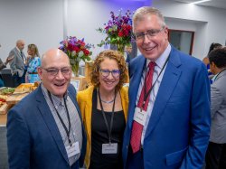 Three people pose for a photo.
