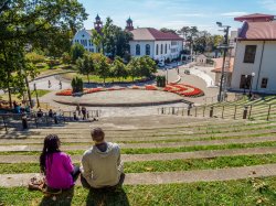 Students sitting on top steps of outdoor amphitheater