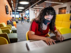 Student with mask in The Graduate School building at Montclair State