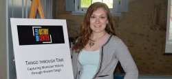 Student Torri Brouhard standing in front of a poster board that says "Montclair History Center: Tango Through Time - Capturing Montclair History through Vincent Tango."