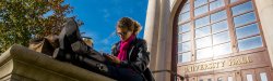 Woman reading on campus on a sunny day