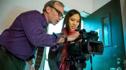 Professor teaching student how to use motion camera.