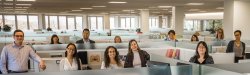 University Communications team standing in cubicles