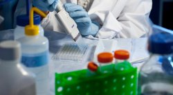 Closeup of student using pipettes in lab