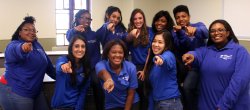 Group of students dressed in IT Service Desk blue shirt