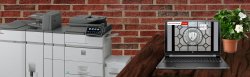 Laptop with printers in the background