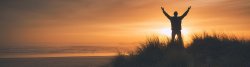 photo of a Man on the sand dunes at the sunset