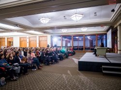 Photo of auditorium filled with people