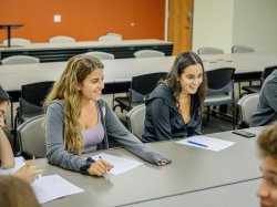 Image of a small Italian language class with two smiling students.