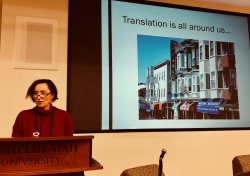 Teresa Fiore speaking in front of slide