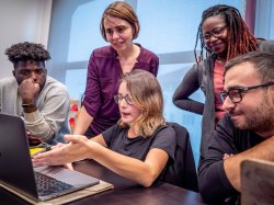 Photo of students working on a laptop