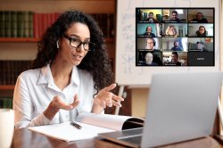 Woman wearing eyeglasses and wireless earbuds, talking to webcam, explaining