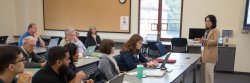 aisian female ITDS Instructor speaking to attendees at a workshop