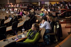 Group of seated attendees focusing on a presentation
