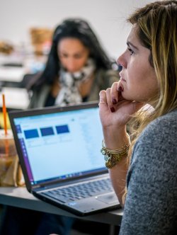 female student at desk with laptop