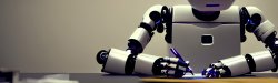 Photo of a robot writing with a pencil.