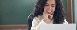 Young woman school teacher working on laptop