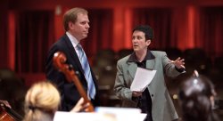 Jennifer Higdon discusses her composition, "blue cathedral" with orchestra conductor Paul Hostetter at a rehearsal in the Kasser Theater.