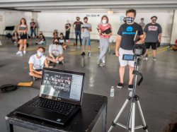 View of laptop and camera broadcasting students over zoom