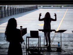 silhouette of choir director speaking to the group