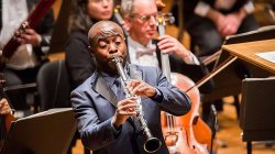 Clarinetist in front of orchestra