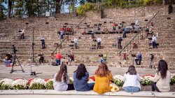 Performers spread on amphitheater steps
