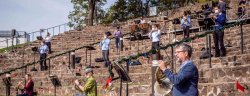 Performers spread on amphitheater steps