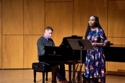 Pathways program vocalist in front of accompanist on stage