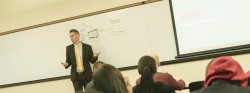 Image of faculty member Arnaud Kurze presenting in a classroom.