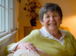 Irene Douma posed on couch in living room