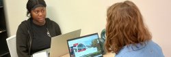 student with librarian in office
