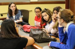 Image of faculty member Anna Feldman talking with Linguistics students.