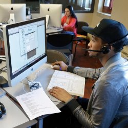 Image of 2 students using computers in a language lab.