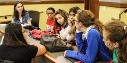 Image of students listening to a linguistics faculty member.