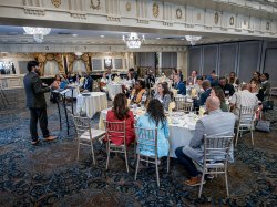 President Koppell speaking to people gathered in a ballroom