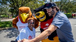 Rocky the Red Hawk and Deacon the Bear pose with President Koppell and Chancellor Evans