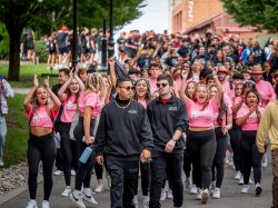 A large group of students walking on campus