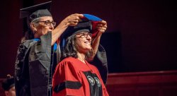 Dr. Zareen Rahman being hooded by her mentor, Dr. Eileen Murray