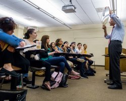 physics professor showing class concave lense