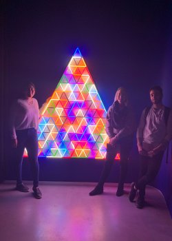 students with illuminated rainbow triangle