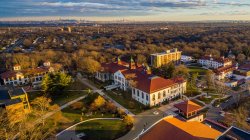 aerial view of campus at sunset with NYC skyline in background