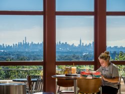 Studen in lounge overlooking NYC skyline