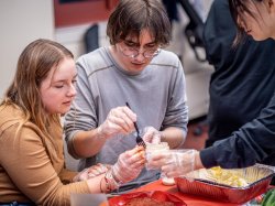 Two participants dish out ingredients for Kimchi