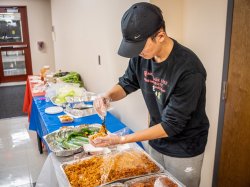 Man serves himself some Kimchi