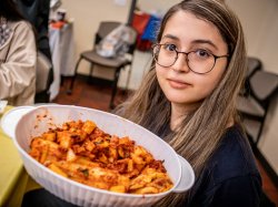 "Participant holds up a bowl of Kimchi"