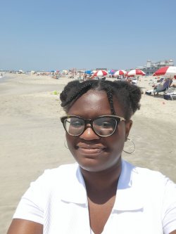 photo of woman smiling on the beach