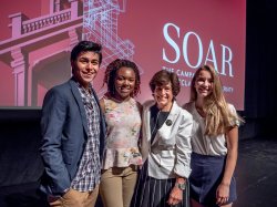 President Cole with students in front of a screen with SOAR campaign graphic