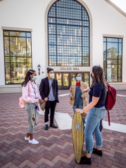 group of students gathered in courtyard behind college hall