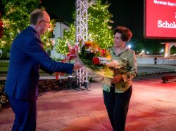 Montclair State University Board of Trustees Chair Francis M. Cuss presents President Cole a bouquet.